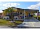 Charming home featuring carport, palm tree, and a cozy seating area, perfect for enjoying outdoor living at 7129 El Rancho Way, Zephyrhills, FL 33541
