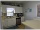 Well-maintained kitchen with white cabinets, stainless steel appliances, and ample counter space at 7129 El Rancho Way, Zephyrhills, FL 33541