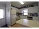Efficient kitchen with white cabinetry, stainless steel dishwasher and a breakfast bar area at 7129 El Rancho Way, Zephyrhills, FL 33541