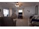 Cozy living room featuring comfortable seating and a ceiling fan for added comfort at 7129 El Rancho Way, Zephyrhills, FL 33541