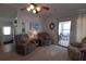 Cozy living room featuring plush seating, natural light, and access to the sunroom at 7129 El Rancho Way, Zephyrhills, FL 33541