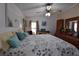 Comfortable bedroom featuring a large bed, a dresser, and plenty of natural light at 7129 El Rancho Way, Zephyrhills, FL 33541