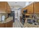 Well-equipped kitchen featuring granite countertops, stainless steel appliances, and wood cabinetry at 8359 Wrens Way Pass, Largo, FL 33773