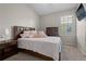 Well-furnished bedroom with a queen bed and a TV with plenty of natural light at 8835 Moonlit Meadows Loop, Riverview, FL 33578