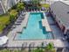 Aerial view of the community pool, surrounded by lounge chairs and landscaping at 8835 Moonlit Meadows Loop, Riverview, FL 33578