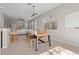 Bright dining area featuring a wooden table, bench seating, and natural lighting at 8835 Moonlit Meadows Loop, Riverview, FL 33578