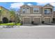 Two story townhome featuring a three car garage and an open balcony at 8835 Moonlit Meadows Loop, Riverview, FL 33578