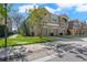 Two story townhome with three car garage and an open balcony, surrounded by lush landscaping at 8835 Moonlit Meadows Loop, Riverview, FL 33578