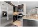 Modern kitchen with stainless steel appliances, granite countertops and dark wood cabinets at 8835 Moonlit Meadows Loop, Riverview, FL 33578