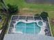 Aerial view of a screened pool area with pool and hot tub, showcasing the backyard layout at 10251 Oasis Palm Dr, Tampa, FL 33615