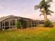 Spacious backyard featuring a large screened-in enclosure, offering an outdoor entertainment area at 10251 Oasis Palm Dr, Tampa, FL 33615