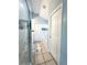 Bathroom view featuring a walk-in shower, bathtub, and double doors to a closet at 10251 Oasis Palm Dr, Tampa, FL 33615