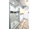 Modern bathroom featuring a glass-enclosed shower with decorative tile and double sinks at 10251 Oasis Palm Dr, Tampa, FL 33615