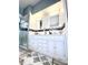 Bathroom with double sinks, decorative tile, and a walk in shower at 10251 Oasis Palm Dr, Tampa, FL 33615