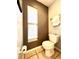 Small bathroom with a toilet and a window for natural light at 10251 Oasis Palm Dr, Tampa, FL 33615