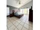 Spacious bedroom with vaulted ceilings, tile flooring, and a ceiling fan at 10251 Oasis Palm Dr, Tampa, FL 33615