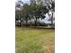 Expansive green space featuring mature trees and a decorative fountain, perfect for a stroll and enjoying nature's beauty at 10251 Oasis Palm Dr, Tampa, FL 33615