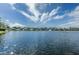 Scenic view of the lake, displaying waterfront properties across the water and bright blue skies at 10251 Oasis Palm Dr, Tampa, FL 33615