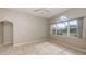 Neutral walls and large arched window enhance the brightness of the living space at 10251 Oasis Palm Dr, Tampa, FL 33615