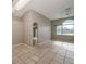 Bright living space with an arched window and doorway leading to the kitchen at 10251 Oasis Palm Dr, Tampa, FL 33615