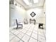 Bright sitting room with tiled floors, vaulted ceilings, and modern artwork at 10251 Oasis Palm Dr, Tampa, FL 33615