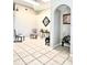 Bright sitting room with tiled floors, vaulted ceilings, and modern artwork at 10251 Oasis Palm Dr, Tampa, FL 33615