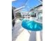 Sparkling blue pool surrounded by a screened enclosure and a gray concrete deck, creating an inviting backyard oasis at 10251 Oasis Palm Dr, Tampa, FL 33615