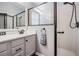 Bathroom featuring a glass-enclosed shower, tile walls, vanity, and a granite countertop at 11044 Jenkins Ct, San Antonio, FL 33576