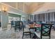 Interior shot of the dining room with tall ceilings, large windows and comfortable seating at 11044 Jenkins Ct, San Antonio, FL 33576