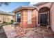 Close up of the front porch, featuring brick pavers and a small bench to enjoy the outdoors at 11044 Jenkins Ct, San Antonio, FL 33576