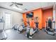 Bright gym area complete with multiple elliptical machines, TV and fan at 11044 Jenkins Ct, San Antonio, FL 33576