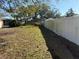 Wide shot of the fenced in backyard with green lawn and view of a storage shed on the side of the property at 11470 88Th Ter, Seminole, FL 33772