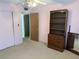 Bedroom with a closet, an open door, and a wooden dresser with shelving at 11470 88Th Ter, Seminole, FL 33772
