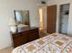 This bedroom has a closet, dresser and mirror, and a soft, neutral color palette at 11470 88Th Ter, Seminole, FL 33772