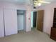 Bedroom with a closet, open doorway, and a wooden dresser with shelving at 11470 88Th Ter, Seminole, FL 33772