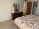 This bedroom has a closet, dresser and mirror, and a soft, neutral color palette at 11470 88Th Ter, Seminole, FL 33772