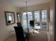 Bright dining room featuring a glass table, chandelier, and sliding doors to the patio at 11470 88Th Ter, Seminole, FL 33772