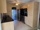 A modern kitchen with tile floors, stainless steel appliances, and wooden cabinets at 11470 88Th Ter, Seminole, FL 33772