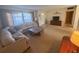 Cozy living room with plush sectional sofa, large window, and neutral carpet at 11470 88Th Ter, Seminole, FL 33772