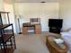 Living area with desk, TV, and comfortable seating, providing a versatile space at 11470 88Th Ter, Seminole, FL 33772