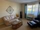 Comfortable living room featuring sofa, arm chair, and neutral carpet at 11470 88Th Ter, Seminole, FL 33772
