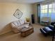 Comfortable living room featuring sofa, arm chair, and neutral carpet at 11470 88Th Ter, Seminole, FL 33772