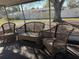 Outdoor patio set with seating, a screened enclosure, and view of the backyard at 11470 88Th Ter, Seminole, FL 33772