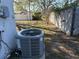 Exterior side yard with a newer HVAC system and a view of the backyard fencing and mature landscaping at 11470 88Th Ter, Seminole, FL 33772