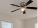 Bedroom ceiling fan with dark blades and integrated light at 14381 116Th Ave, Largo, FL 33774