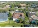 Overhead view of a home featuring a screened-in pool, lush greenery, and a tranquil residential setting at 15720 Ibisridge Dr, Lithia, FL 33547