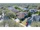 Aerial shot of a home with a screened-in pool, well-manicured lawn, and a charming neighborhood at 15720 Ibisridge Dr, Lithia, FL 33547