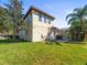 Spacious backyard featuring a well-maintained lawn, mature trees, and a glimpse of the screened-in patio at 15720 Ibisridge Dr, Lithia, FL 33547