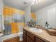 Bathroom featuring a vanity, framed mirror and a shower/bath with a colorful, decorative curtain at 15720 Ibisridge Dr, Lithia, FL 33547