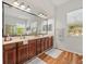 Elegant bathroom featuring dual sinks, a large mirror, and plenty of cabinet space at 15720 Ibisridge Dr, Lithia, FL 33547